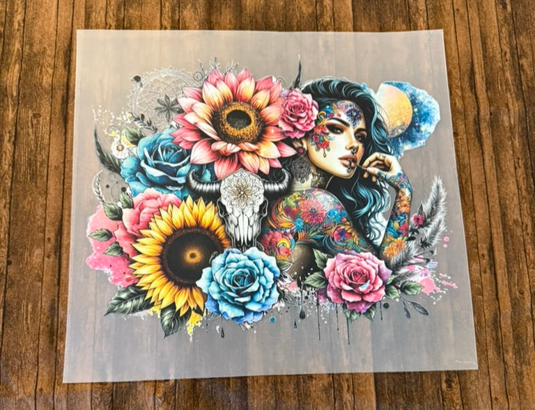 Colorful tattoo design of a woman with flowers on a wooden surface